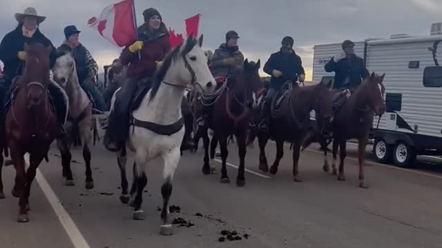 500 Canadian cowboys and cowgirls on horse back going right around police blockade at USA border