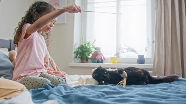 Kids Playing With Their Black Cat