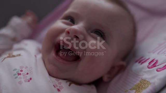 Close-up video of a little baby smiling and laughing stock video