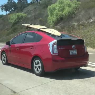 Red prius surfboard on roof