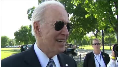 Biden looks at a little girls