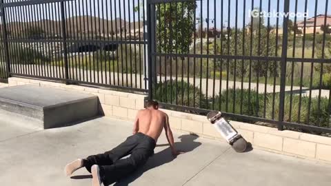 Guy goes for a skateboard trick and falls off. skateboard flies over his head