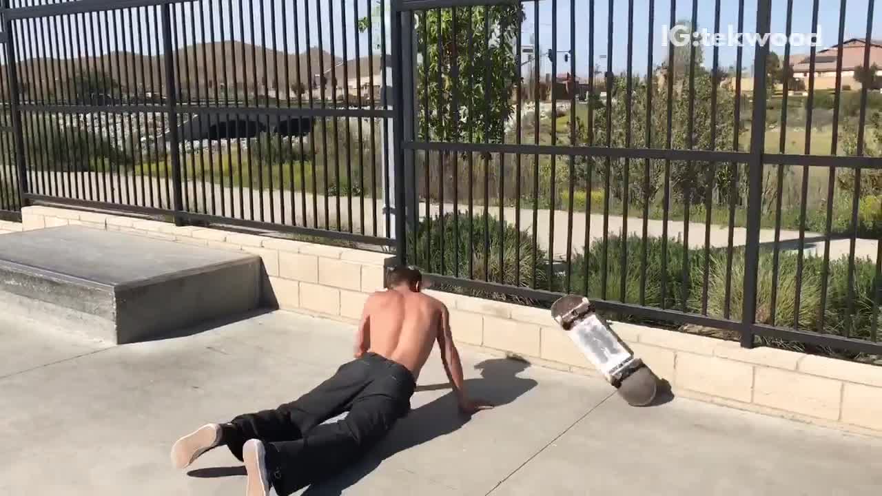Guy goes for a skateboard trick and falls off. skateboard flies over his head