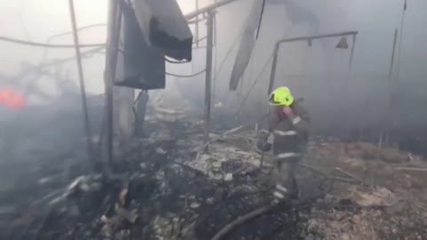 Firefighters tackle HUGE blaze at bombed shopping mall - at least 10 killed