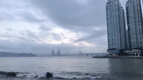 Cloudy sea, sky and city