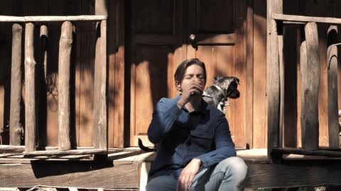 Man drinking coffee out his cabin