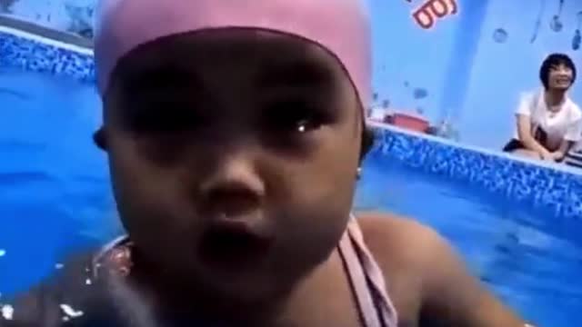 Very cute little baby swimming