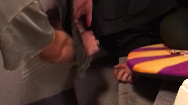 Guy tries to surf down stairs with orange boogie board