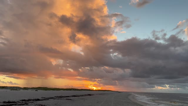 Beautiful storm clouds with the sunrise at the beach