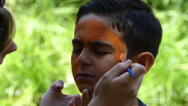 Face painting is a popular activity for the kids