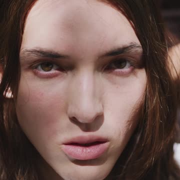 A Woman Covering the Eyes of a Man with Her Hands