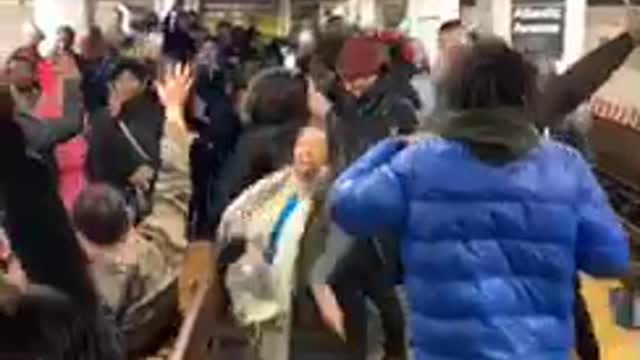 People sing and dance to mo bamba together in subway station