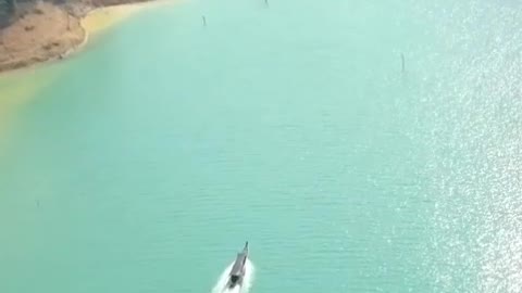 Motorboat sailing in a bay on a sunny day