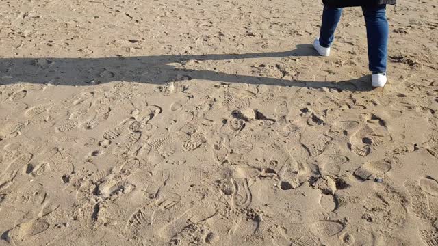A man walking on the sand