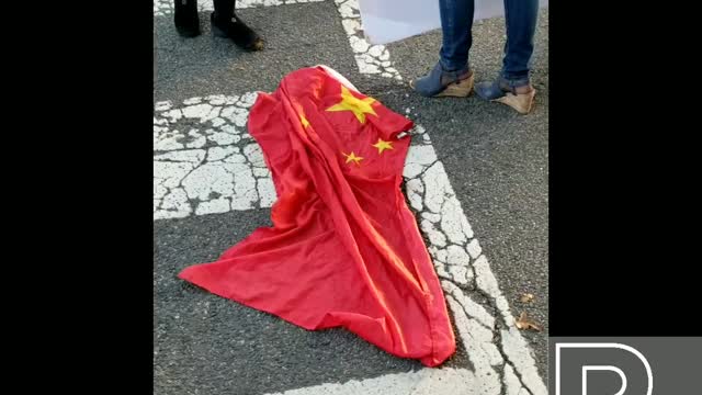 American Protesters stomp on the Chinese Communist Flag