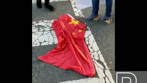 American Protesters stomp on the Chinese Communist Flag