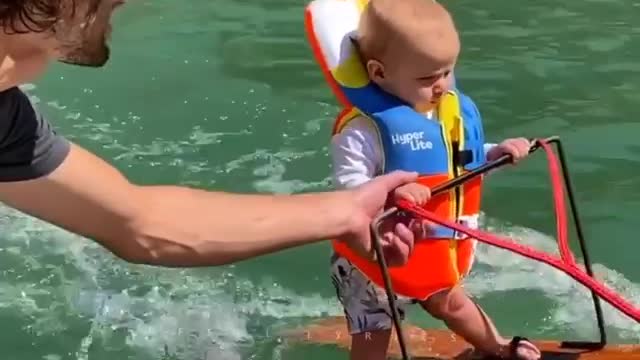 USA baby is having fun in the water,