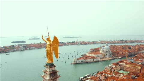 golden statue of angel on top of clock tower in st marks square