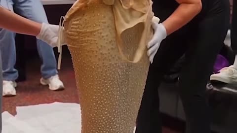 Kim Kardashian trying on Marilyn Monroe's dress for the Met Gala for the first time.
