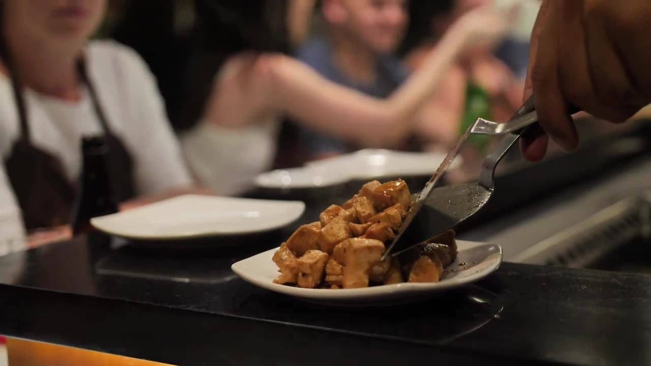 Waiter serving meat stew in a restaurant