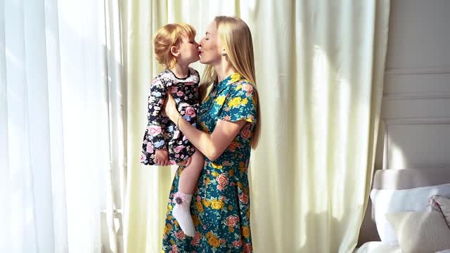 A Daughter Giving Her Mother A Kiss