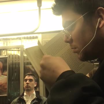 A man smells the pages on book