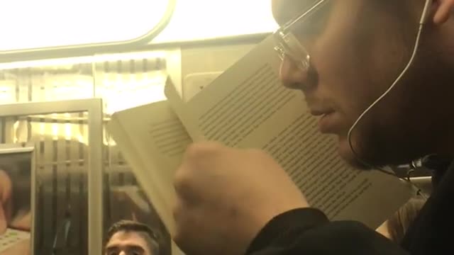 A man smells the pages on book