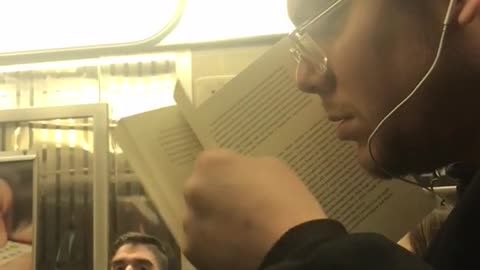 A man smells the pages on book