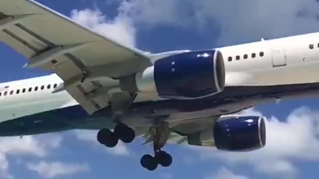 A plane flying over the beach