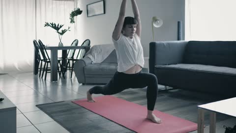 Girl practicing yoga in a living room at home