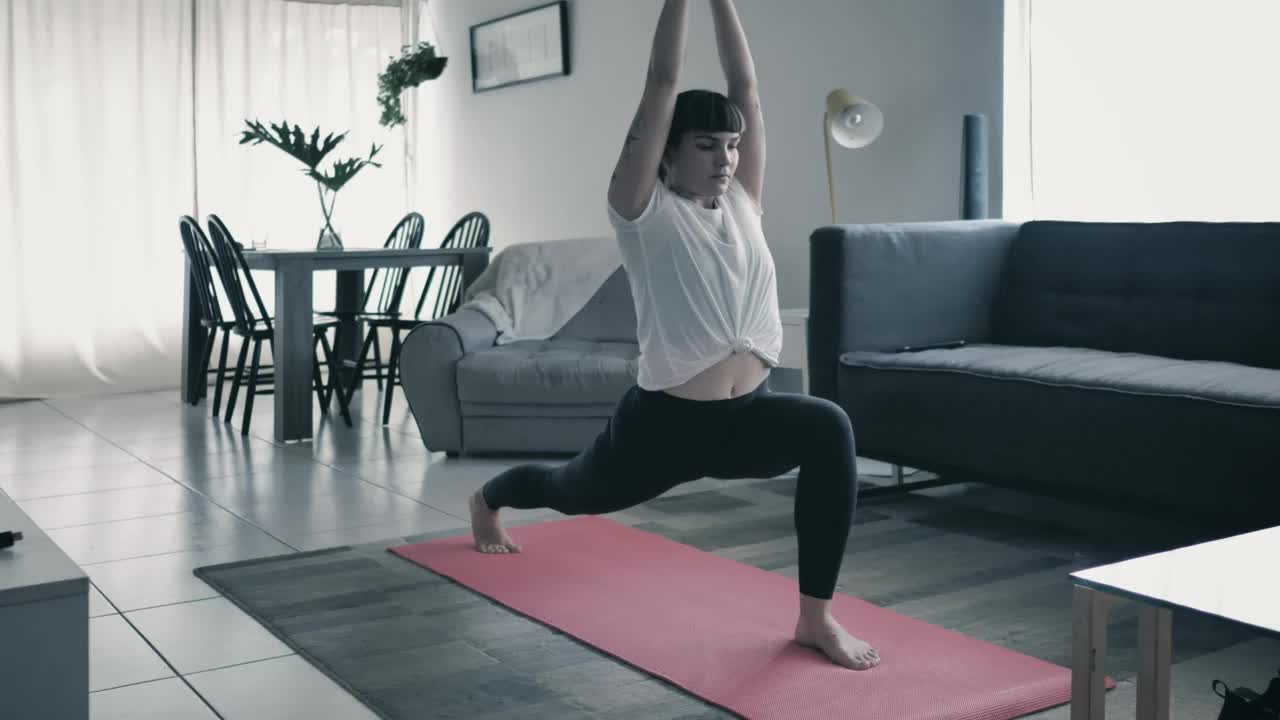 Girl practicing yoga in a living room at home