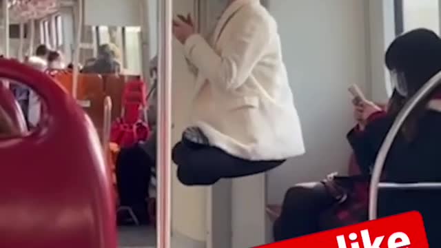 Woman ties her hair to train handrail!