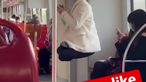 Woman ties her hair to train handrail!