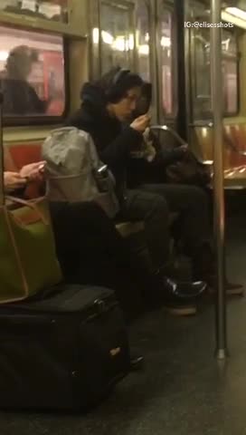 Woman eats ramen on subway train