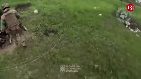 Ukrainian fighters display the killed Russians and the captured weapons near Bakhmut