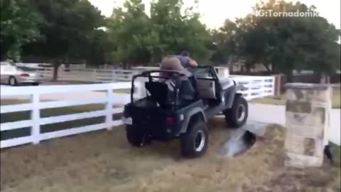 Guy in grey shirt on top of jeep laying down