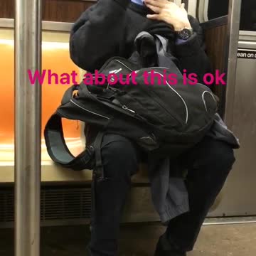 Guy all black wearing glasses shaving on subway
