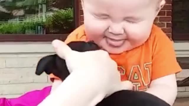 Baby first kiss with puppy