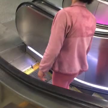 Pink shirt guy can barely stand on escalator