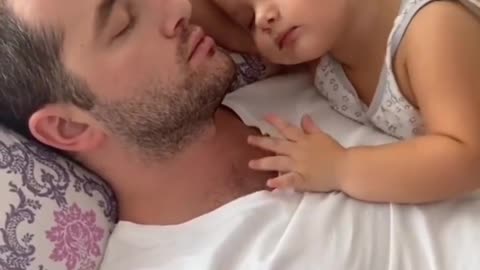 Little girl cuddling the dady when sleeping