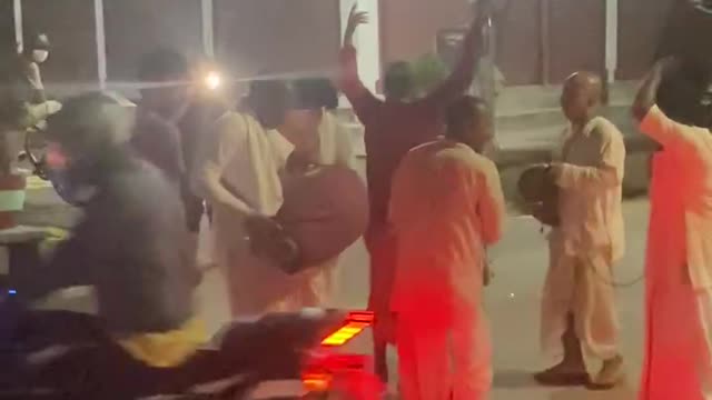 Hindu pandit dancing and playing intruements singing songs praying god