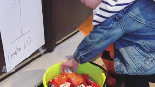Kid makes the most of trick-or-treat candy bucket