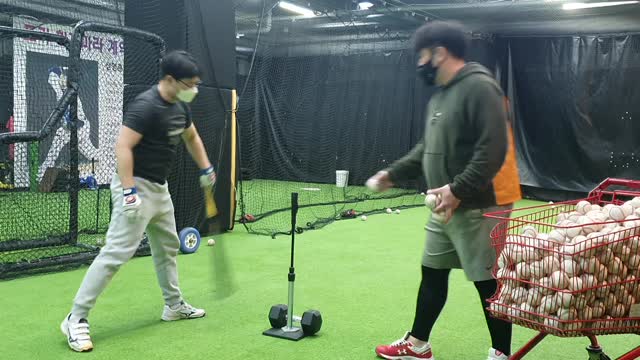 Amateur baseball player practicing batting