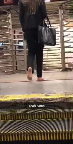 Business woman barefoot on escalators