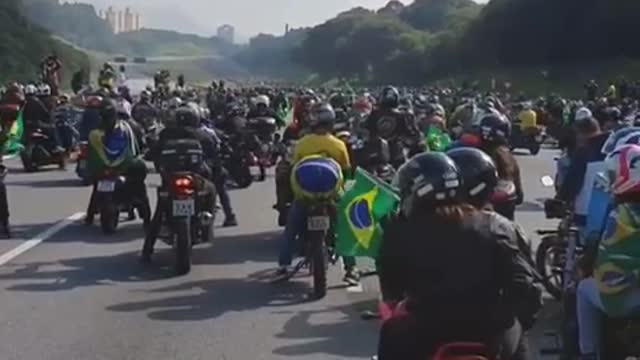 President Jair Bolsonaro participates in Motociata in Brazil and is followed by crowd