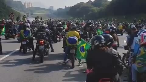 President Jair Bolsonaro participates in Motociata in Brazil and is followed by crowd