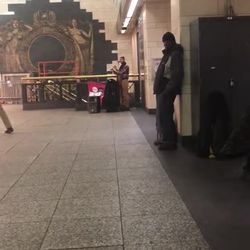 Couple and old man dance to flute dance music in subway station