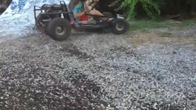 Long hair guy on go cart jumps ramp then downs a beer