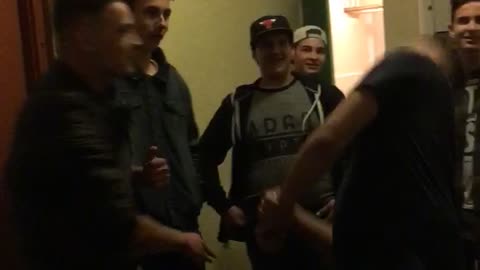 Music guy slaps his friend wearing black and knocks him to the ground