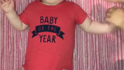 Toddler grabs ahold of her baby brother and says cheese